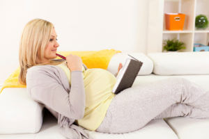 Pregnant woman writing